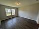 Bright bedroom featuring modern flooring, neutral walls, and natural light from two windows at 10891 Sweetsen Rd, Camby, IN 46113