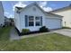Charming single-story home featuring a well-manicured lawn, two-car garage, and classic architectural details at 10891 Sweetsen Rd, Camby, IN 46113
