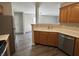 A bright kitchen featuring stainless steel appliances and dark wood cabinets at 10891 Sweetsen Rd, Camby, IN 46113