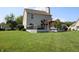 Expansive backyard featuring a wooden deck with a charming pergola and ample green space at 10949 Haig Point Dr, Fishers, IN 46037