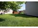 Spacious backyard featuring a well-maintained lawn, mature trees, and play set at 10949 Haig Point Dr, Fishers, IN 46037