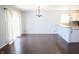 Open-concept dining area with hardwood floors, a chandelier, and sliding glass doors leading to the outside at 10949 Haig Point Dr, Fishers, IN 46037