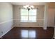 Simple dining room with hardwood floors, large window and modern chandelier at 10949 Haig Point Dr, Fishers, IN 46037