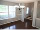 Bright dining room featuring a decorative chandelier, large windows, and hardwood floors at 10949 Haig Point Dr, Fishers, IN 46037