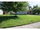 Beautifully landscaped front yard with a large tree providing shade and curb appeal at 10949 Haig Point Dr, Fishers, IN 46037