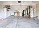 Spacious garage featuring ample storage space with cabinets, workbench and a water heater at 10949 Haig Point Dr, Fishers, IN 46037