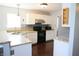 Well-lit kitchen with granite countertops, stainless steel appliances, white cabinets, and hardwood flooring at 10949 Haig Point Dr, Fishers, IN 46037
