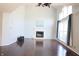Bright living room featuring hardwood floors, vaulted ceilings, a fireplace, and large windows at 10949 Haig Point Dr, Fishers, IN 46037