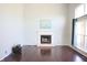 Bright living room features a fireplace, large windows with curtains, and gleaming hardwood floors at 10949 Haig Point Dr, Fishers, IN 46037