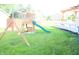 Backyard featuring a wooden swing set with a slide, perfect for outdoor fun and play at 10949 Haig Point Dr, Fishers, IN 46037