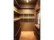 Walk in wine cellar with custom-built shelving and tiled flooring at 10949 Haig Point Dr, Fishers, IN 46037