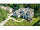 Aerial view of a charming home with lush greenery, well-manicured lawn, and a curving walkway at 11350 Old Stone Dr, Indianapolis, IN 46236