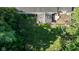 Aerial view of a green backyard with a wooden deck, a covered table, and lush landscaping at 11350 Old Stone Dr, Indianapolis, IN 46236
