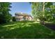 Beautiful backyard with lush lawn and tree line providing privacy at 11350 Old Stone Dr, Indianapolis, IN 46236