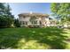 Spacious backyard featuring a lush green lawn and mature trees at 11350 Old Stone Dr, Indianapolis, IN 46236