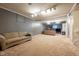 Large finished basement offering neutral carpet, couches, television, and room to entertain Gathering and friends at 11350 Old Stone Dr, Indianapolis, IN 46236
