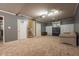 Finished basement with neutral carpet, drop ceiling and built-in shelving for storage and entertainment at 11350 Old Stone Dr, Indianapolis, IN 46236