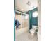 This bathroom features a shower-tub and a unique window at 11350 Old Stone Dr, Indianapolis, IN 46236