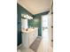 This bathroom has a double sink vanity and dark turquoise walls at 11350 Old Stone Dr, Indianapolis, IN 46236