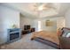 Large bedroom with a fireplace, mounted tv and tray ceiling with ceiling fan at 11350 Old Stone Dr, Indianapolis, IN 46236