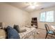 This bedroom features a ceiling fan, neutral walls, carpet, and double door closet at 11350 Old Stone Dr, Indianapolis, IN 46236