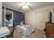 Bedroom featuring a ceiling fan, closet and blue accent wall at 11350 Old Stone Dr, Indianapolis, IN 46236