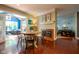 Bright dining area with fireplace, seating, access to sunroom, hardwood floors, and natural light at 11350 Old Stone Dr, Indianapolis, IN 46236
