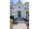Close-up of front door with wreath, potted flowers, and welcome mat, creating an inviting entrance at 11350 Old Stone Dr, Indianapolis, IN 46236