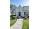 Inviting front entrance features a black door, seasonal flowers, and an arched entryway at 11350 Old Stone Dr, Indianapolis, IN 46236
