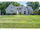 Elegant two-story white brick home with well-manicured lawn and mature trees, showcasing classic curb appeal at 11350 Old Stone Dr, Indianapolis, IN 46236