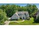 Stunning two-story home boasts a lush front yard, mature trees, and manicured landscaping at 11350 Old Stone Dr, Indianapolis, IN 46236