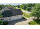 Three-car garage with an extra door to the backyard and an extended driveway at 11350 Old Stone Dr, Indianapolis, IN 46236