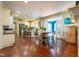 Open concept kitchen and dining room with stainless appliances, island, and hardwood flooring throughout at 11350 Old Stone Dr, Indianapolis, IN 46236