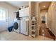 Spacious laundry room with washer, dryer, and folding area at 11350 Old Stone Dr, Indianapolis, IN 46236