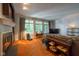Well-lit living room showcases large windows, warm carpet, fireplace, TV, and comfortable seating at 11350 Old Stone Dr, Indianapolis, IN 46236