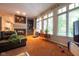 Spacious living room with a fireplace, natural light, hardwood floors, and comfortable seating area at 11350 Old Stone Dr, Indianapolis, IN 46236