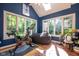 Bright sun room with skylights, tiled floors, seating, and exercise bike at 11350 Old Stone Dr, Indianapolis, IN 46236