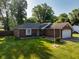 Charming brick home with attached garage, well-manicured lawn, and mature trees in a desirable neighborhood at 12113 N Rooker Rd, Mooresville, IN 46158