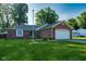 Charming brick home with a well-manicured lawn and attached two car garage at 12113 N Rooker Rd, Mooresville, IN 46158