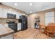 Kitchen with stainless steel appliances, white cabinets, and adjacent breakfast area at 12113 N Rooker Rd, Mooresville, IN 46158