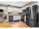 Modern kitchen featuring stainless steel appliances, white cabinets, and wood flooring at 12113 N Rooker Rd, Mooresville, IN 46158
