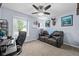 The office space features neutral carpet, ceiling fan and lighting, and leather couch at 12113 N Rooker Rd, Mooresville, IN 46158