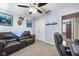 The office space has neutral carpet, ceiling fan and lighting, and a comfortable leather couch at 12113 N Rooker Rd, Mooresville, IN 46158
