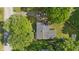 Aerial view of a home with lush landscaping, mature trees, and a private driveway at 1302 N Furman Ave, Indianapolis, IN 46214