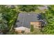 Aerial view of a home featuring mature trees, and a dark grey roof at 1302 N Furman Ave, Indianapolis, IN 46214