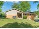 Expansive backyard featuring a patio, lush lawn, mature trees, and secure fencing at 1302 N Furman Ave, Indianapolis, IN 46214