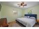 Cozy bedroom with a comfortable bed, two windows providing ample natural light, and ceiling fan at 1302 N Furman Ave, Indianapolis, IN 46214
