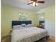 Bedroom featuring a queen-sized bed, mirrored closet, and neutral carpet at 1302 N Furman Ave, Indianapolis, IN 46214