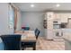 Bright dining room with table and kitchen featuring white cabinets at 1302 N Furman Ave, Indianapolis, IN 46214