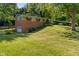 Inviting split-level home with a garage and lush greenery at 1302 N Furman Ave, Indianapolis, IN 46214